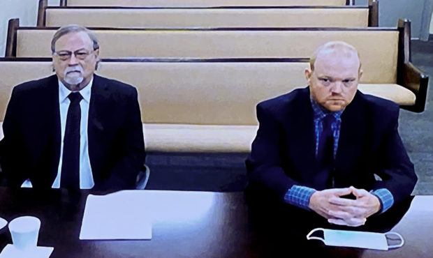 In this image made from video, from left, father and son, Gregory and Travis McMichael, accused in ...