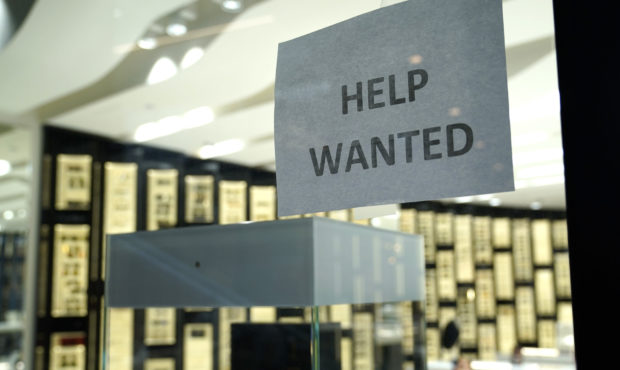 Image of a help wanted sign. There aren't as many jobs that offer remote work as there were during ...