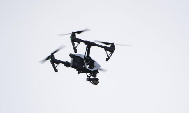 FILE - In this Thursday, Aug. 8, 2019, file photo, a drone flies in a residential neighborhood in U...