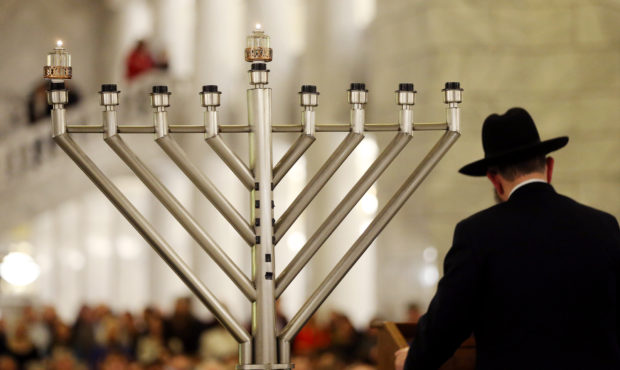 FILE -- Rabbi Benny Zippel of Chabad Lubavitch of Utah conducts the ceremony as the lighting of a m...
