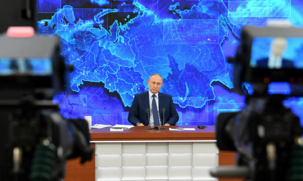 Russian President Vladimir Putin addresses his annual press conference via a video link at the Novo...