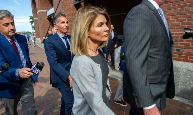 Actress Lori Loughlin and husband Mossimo Giannulli exit the Boston Federal Court house after a pre...