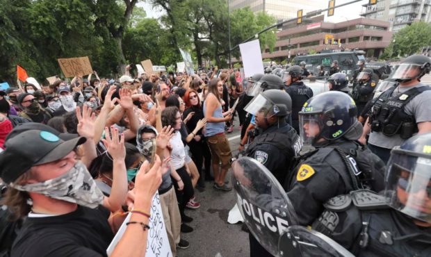 (Protesters go face-to-face with shielded police officers.  Credit:  Jeffrey D. Allred, Deseret New...