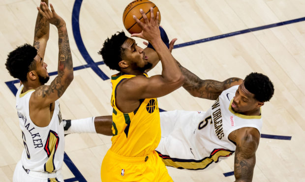 FILE: Utah Jazz guard Donovan Mitchell (45) draws the foul from New Orleans Pelicans guard Eric Ble...