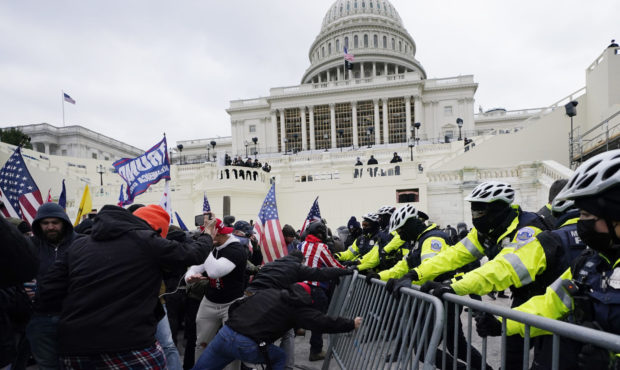 Trump supporters try to break through a police barrier, Wednesday, Jan. 6, 2021, at the Capitol in ...