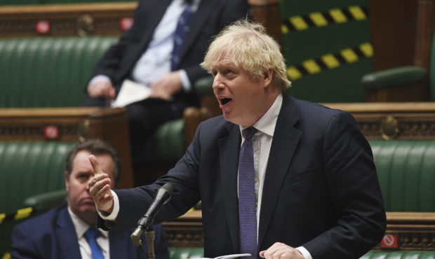 In this handout photo provided by UK Parliament, Britain's Prime Minister Boris Johnson makes a sta...