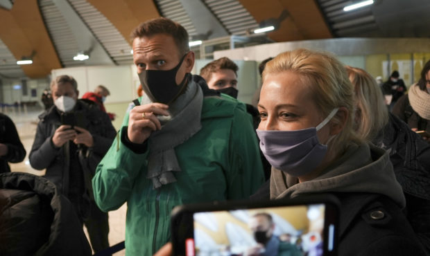 Alexei Navalny and his wife Yuliastand in line at the passport control after arriving at Sheremetye...
