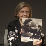 This photo provide by the World Jewish Congress, Tova Friedman, an 82-year-old Polish-born Holocaust survivor holding a photograph of herself as a child with her mother, who also survived the Nazi death camp Auschwitz, in New York, Friday, Dec.13, 2019.  Friedman is delivering a warning against rising hatred in the world during an online commemoration on Wednesday, the 76th anniversary of the liberation of Auschwitz by Soviet troops at end of World War II. The commemorations for the victims of the Holocaust at the International Holocaust Remembrance Day, marking the liberation of Auschwitz-Birkenau on Jan. 27, 1945, will be mostly online in 2021 due to the coronavirus pandemic. (World Jewish Congress via AP)