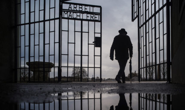 File - In this Sunday, Jan. 27, 2019 file photo, a man walks through the gate of the Sachsenhausen ...