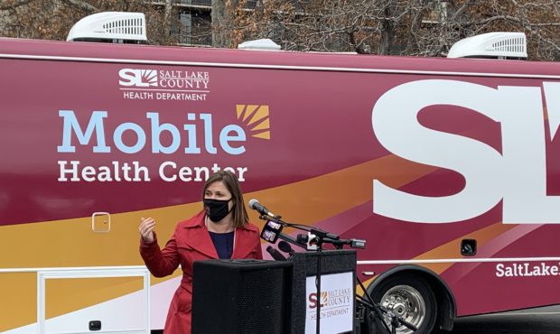 (Salt Lake County Mayor Jenny Wilson standing in front of the county's two new mobile health center...