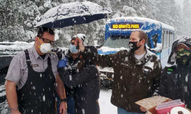 Oregon health workers administer the Moderna coronavirus vaccine to stranded motorists during a sno...