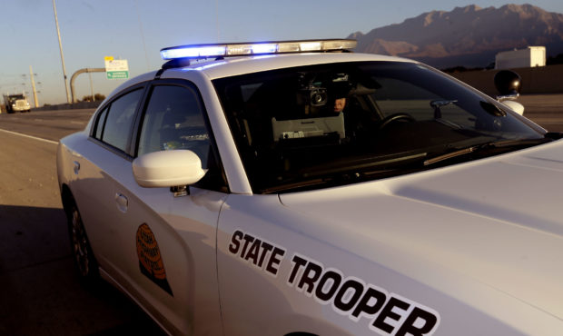 FILE -- A Utah Highway Patrol trooper searches information on his computer on I-15 in Utah County o...