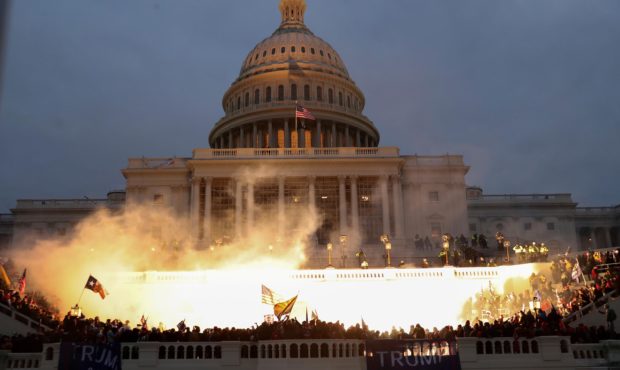 FILE PHOTO: An explosion caused by a police munition is seen while supporters of U.S. President Don...