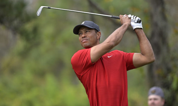 FILE - Tiger Woods watches his tee shot on the fourth hole during the final round of the PNC Champi...
