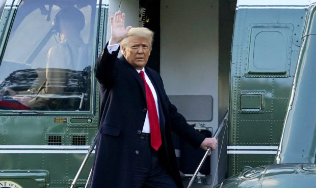 FILE - In this Wednesday, Jan. 20, 2021, file photo, President Donald Trump waves as he boards Mari...
