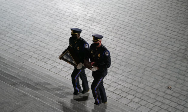 An honor guard carries an urn with the cremated remains of U.S. Capitol Police officer Brian Sickni...