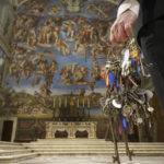 Gianni Crea, the Vatican Museums chief "Clavigero" key-keeper, walks through the Sixtine Chapel as he opens the museum, at the Vatican, Monday, Feb. 1, 2021. Crea is the “clavigero” of the Vatican Museums, the chief key-keeper whose job begins each morning at 5 a.m., opening the doors and turning on the lights through 7 kilometers of one of the world's greatest collections of art and antiquities. The Associated Press followed Crea on his rounds the first day the museum reopened to the public, joining him in the underground “bunker” where the 2,797 keys to the Vatican treasures are kept in wall safes overnight. (AP Photo/Andrew Medichini)