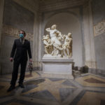 Gianni Crea, the Vatican Museums chief "Clavigero" key-keeper, walks past the Laocoon statue, a masterpiece of the sculptors of Rhodes dated around 40-30 B.C., on his way to open the museum's rooms and sections, at the Vatican, Monday, Feb. 1, 2021. Crea is the “clavigero” of the Vatican Museums, the chief key-keeper whose job begins each morning at 5 a.m., opening the doors and turning on the lights through 7 kilometers of one of the world's greatest collections of art and antiquities. The Associated Press followed Crea on his rounds the first day the museum reopened to the public, joining him in the underground “bunker” where the 2,797 keys to the Vatican treasures are kept in wall safes overnight. (AP Photo/Andrew Medichini)