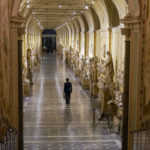 Gianni Crea, the Vatican Museums chief "Clavigero" key- keeper, walks down an aisle on his way to open the museum's rooms and sections, the Vatican, Monday, Feb. 1, 2021. Crea is the “clavigero” of the Vatican Museums, the chief key-keeper whose job begins each morning at 5 a.m., opening the doors and turning on the lights through 7 kilometers of one of the world's greatest collections of art and antiquities. The Associated Press followed Crea on his rounds the first day the museum reopened to the public, joining him in the underground “bunker” where the 2,797 keys to the Vatican treasures are kept in wall safes overnight. (AP Photo/Andrew Medichini)