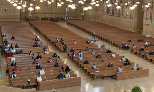 FILE - In this Sunday, June 7, 2020, file photo, a hundred faithful sit while minding social distan...