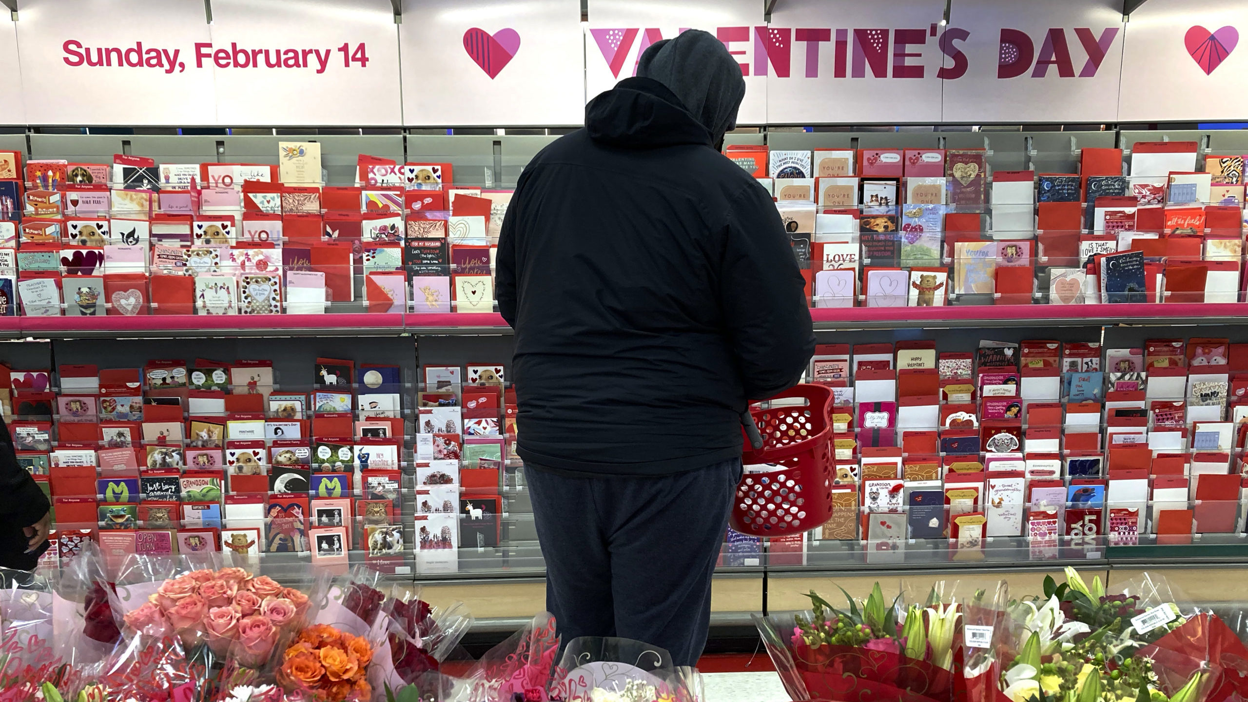 a person looks at valentine's day cards...
