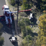 A vehicle rests on its side after a rollover accident involving golfer Tiger Woods Tuesday, Feb. 23, 2021, in the Rancho Palos Verdes suburb of Los Angeles. Woods suffered leg injuries in the one-car accident and was undergoing surgery, authorities and his manager said. (AP Photo/Mark J. Terrill)
