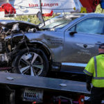 A damaged vehicle is placed on a flatbed truck following a rollover accident involving golfer Tiger Woods, Tuesday, Feb. 23, 2021, in the Rancho Palos Verdes suburb of Los Angeles. Woods suffered leg injuries in the one-car accident and was undergoing surgery, authorities and his manager said. (AP Photo/Ringo H.W. Chiu)