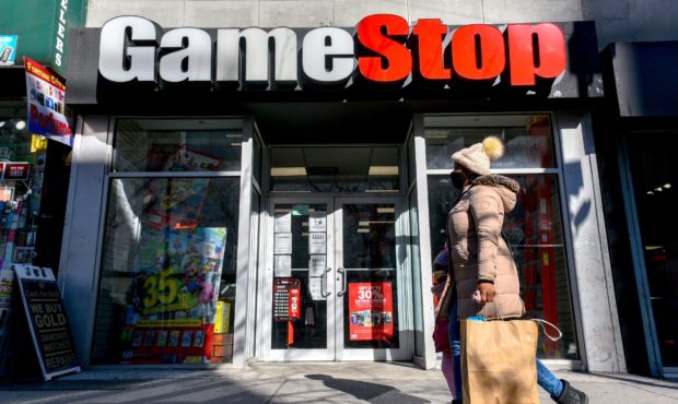 People walk past a GameStop store in Brooklyn, New York on Jan 28. GameStop shares rallied 67% ahea...
