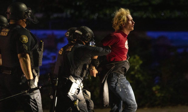 FILE - In this Aug. 30 2020 file photo police make arrests on the scene of protests at a Portland p...