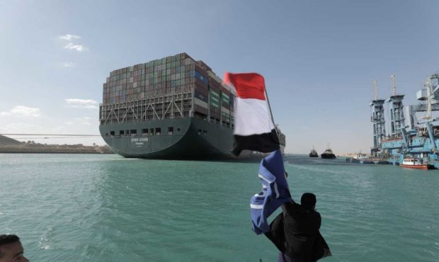 In this photo released by Suez Canal Authority, the Ever Given, a Panama-flagged cargo ship is acco...