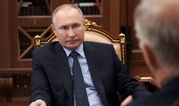Russian President Vladimir Putin listens to General Director of the Russian Direct Investment Fund ...