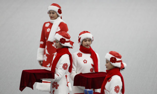 Chinese attendants dressed in winter costumes rehearse the award ceremony of the men's 500-meters r...