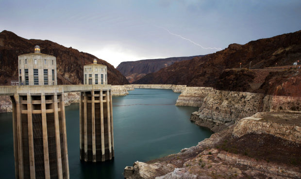 FILE - In this July 28, 2014, file photo, lightning strikes over Lake Mead near Hoover Dam that imp...