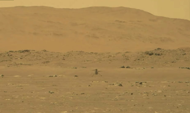 In this image from NASA, NASA's experimental Mars helicopter Ingenuity lands on the surface of Mars...