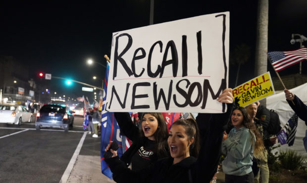 FILE - In this Nov. 21, 2020, file photo, demonstrators shout slogans while carrying a sign calling...