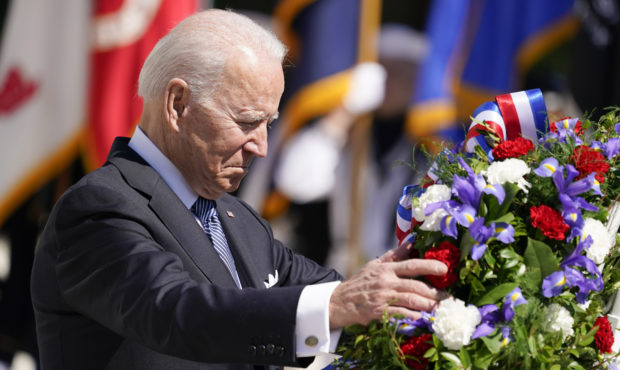 President Joe Biden adjusts a wreath at the Tomb of the Unknown Soldier at Arlington National Cemet...
