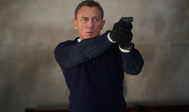 James Bond (Daniel Craig) prepares to shoot in 
NO TIME TO DIE,
an EON Productions and Metro-Goldwy...