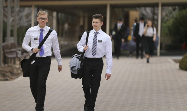 Missionaries for The Church of Jesus Christ of Latter-day Saints walk between buildings at the Miss...