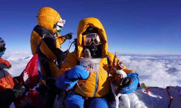Jenn Drummond holds a picture of her seven children atop the summit of Mt. Everest, Monday May 30, ...
