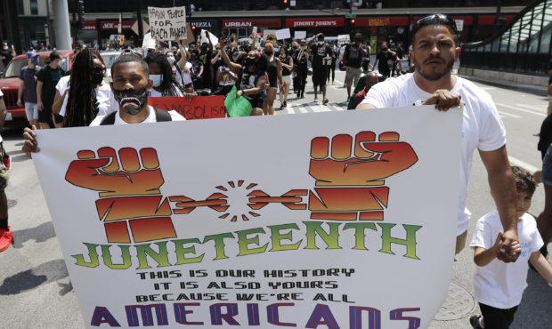 FILE People demonstrate in Chicago, Friday, June 19, 2020, to mark Juneteenth, the holiday celebrat...