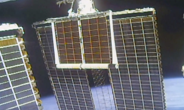 In this image taken from NASA video, a solar panel is unfolded at the International Space Station, ...