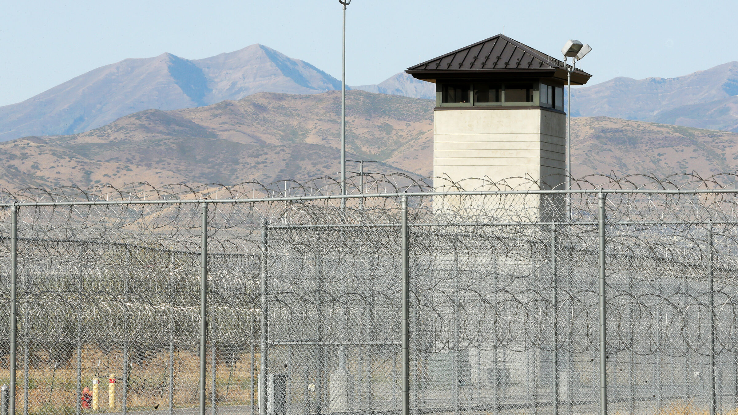A barbed wire fence is shown at a utah prison, whose populations are rising quickly...