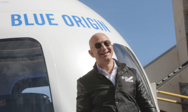 Jeff Bezos, chief executive officer of Amazon.com Inc. and founder of Blue Origin LLC, smiles while...