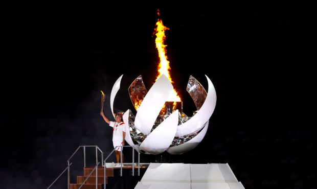 TOKYO, JAPAN - JULY 23: Naomi Osaka of Team Japan lights the Olympic cauldron with the Olympic torc...