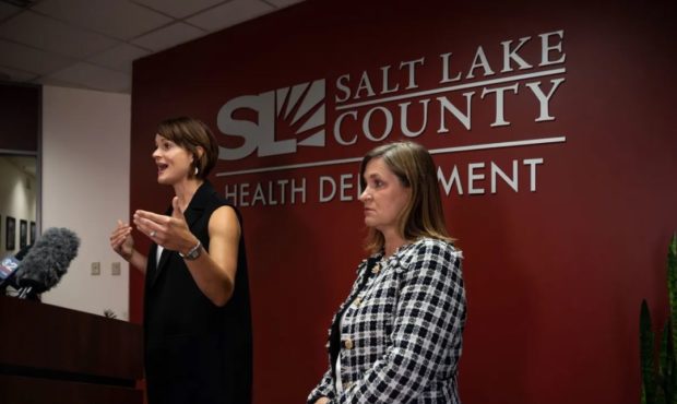 (Salt Lake County Health Department Executive Director Dr. Angela Dunn, left, speaks during a COVID...