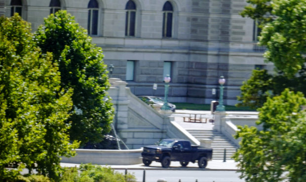 A pickup truck is parked on the sidewalk in front of the Library of Congress' Thomas Jefferson Buil...