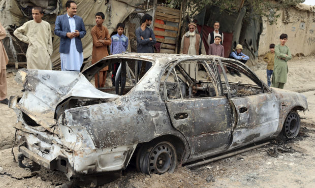 afghanistan family awaits answers next to bombed out car...