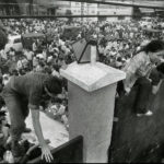 FILE - In this April 29, 1975 file photo, South Vietnamese civilians scale the 14-foot wall of the U.S. embassy in Saigon, trying to reach evacuation helicopters as the last Americans depart from Vietnam. (AP Photo/File)