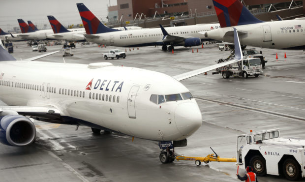 FILE -- A Delta plane departs from a hangar at the Salt Lake City International Airport in Salt Lak...