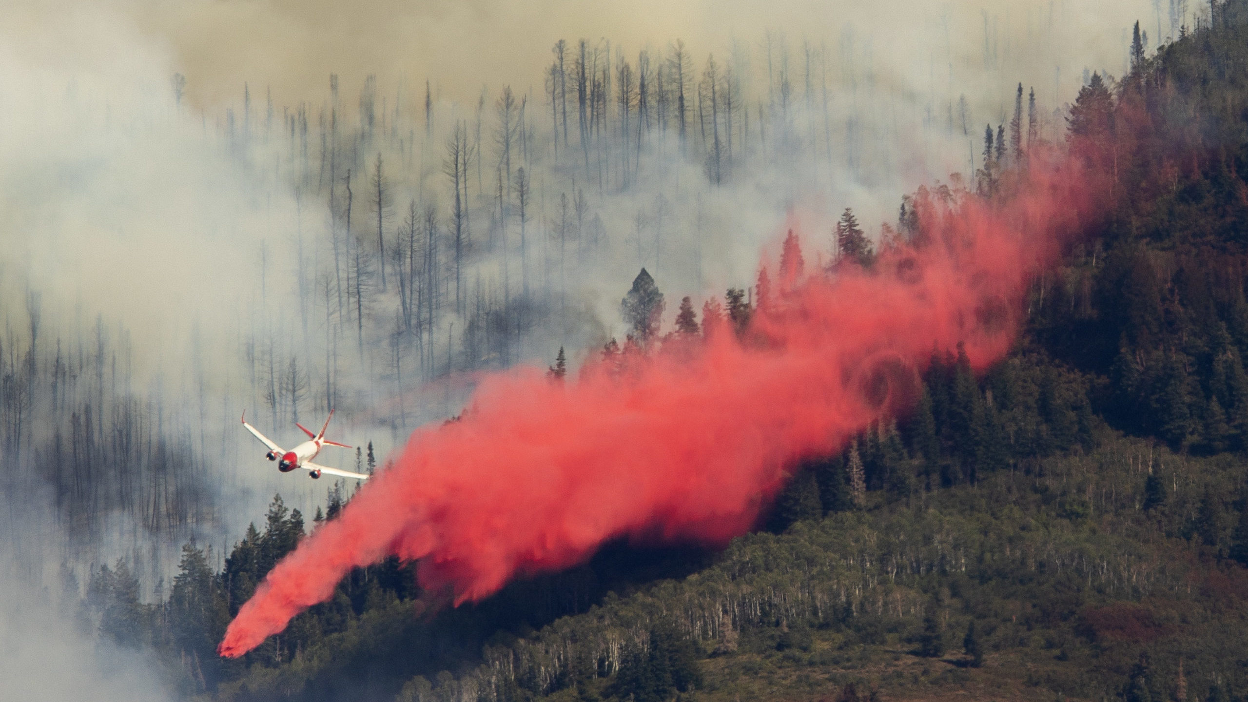 FILE: An air tanker drops retardant on the Parleys Canyon west of Park City on Saturday, Aug. 14, 2...